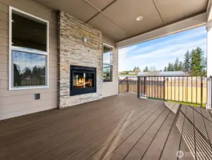 Covered rear patio with fireplace can be enjoyed year around. Imagine starting or ending your day here with a nice fire and peaceful views.