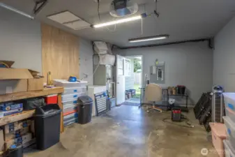 two pedestrian doors, one near front door and access to back yard.