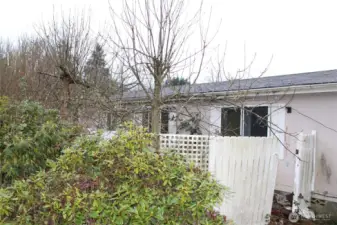 Back of home, partially fenced