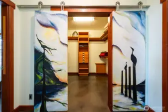 The hand painted shoji-style doors from the primary suite lead to the oversized walk-in closet.