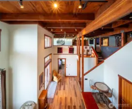 Looking at the lower level from the second floor with the incredible old-growth timbers and wood plank ceiling.