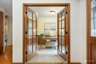 French doors offer privacy and inclusion.  Main floor office has built in shelving.