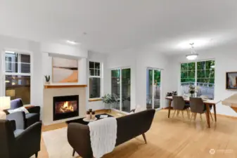 Great room with cozy gas fireplace, bamboo flooring, and wrap around windows, create an inviting atmosphere