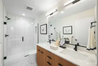 Primary Bathroom offers dual sink vanity, and BIG tiled shower!  Photo is of same floorplan.  Color schemes vary by location.