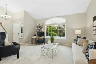 The living room is just off the entrance and has dramatic vaulted ceilings.