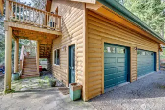 Huge 3-car garage also has a fantastic work shop by the lower side door. Stairs lead to the 1-bedroom apartment.