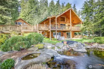 3-car garage and Studio above on the right, main house on left. Stunning waterfall ends in the reciculating pond.