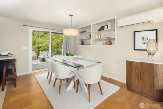 Large dining area with built in shelving and slider to deck.