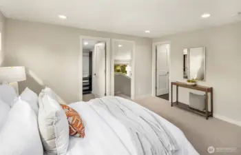 Spacious primary bedroom ensuite with walk in closet, private sitting area and laundry access.