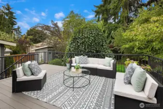 Large deck of dining room overlooks back garden oasis.