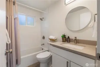 Nicely remodeled bathroom with new vanity and tub.
