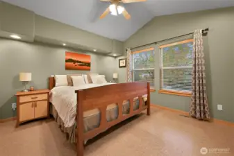 Master bedroom with vaulted ceiling, walk-in closet, and large bathroom