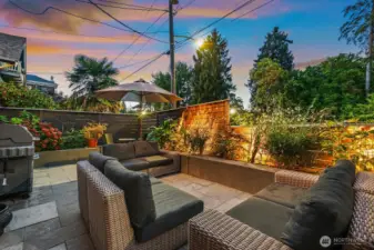 Patio facing north with landscaping lighting and gas plumbed BBQ. There was previously a 2-person hot tub in the corner beyond the open umbrella.