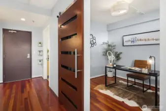 Dedicated home office with barn door access and guest bath off the entry