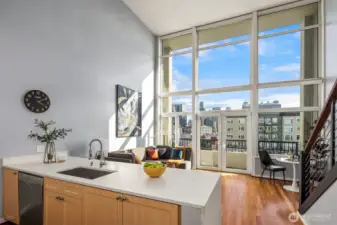 A full wall of floor to ceiling windows flood the interior of the home with natural light