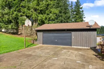 Oversized garage with dedicated workspace for projects or storage.