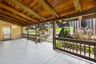 Covered back porch ideal for entertaining, offering a comfortable space to gather with friends, host summer barbecues, and enjoy relaxed evenings with convenient access to the kitchen and garage.