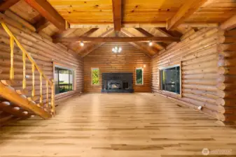 Vaulted ceilings and exposed logs create an inviting great room where memories are made.