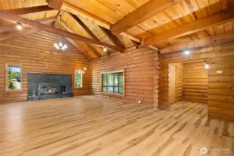 The natural stone fireplace with wood insert creates a warm focal point, ideal for winter evenings and holiday gatherings. A newer Bosch electric furnace and heat pump provide efficient year-round comfort.