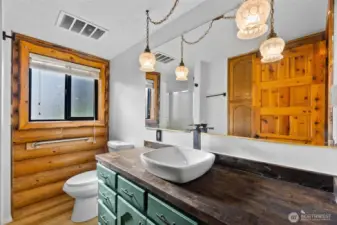 Convenient main-level ¾ bath featuring an updated sink and faucet, adding a touch of luxury.