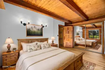 Main-level bedroom virtually staged to showcase primary suite possibilities.