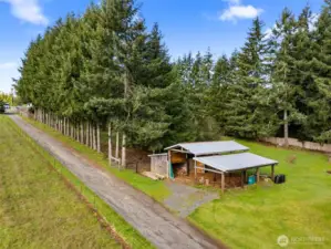 30x30 pole building with 12x30 lean-to carport offering limitless versatility. Mature trees line the property.