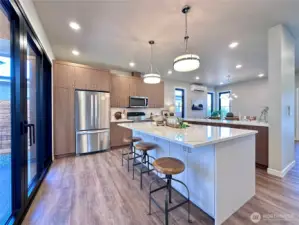 Large kitchen with massive quartz island with eating bar