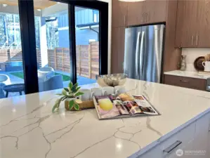 Direct outdoor patio access with modern European sliding French doors.