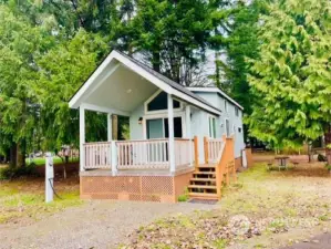 You will find pride of ownership in this lovely, nearly new tiny home tucked back into an idyllic treed lot in this beautiful, well-cared-for park.