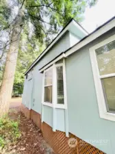 Outside view of bay window that gives extra space for eating nook.