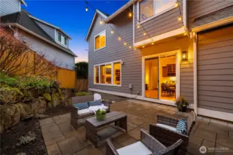 The rear of the house has a large paved patio.