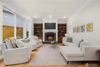 Opposite of the kitchen is the family room. An additional fireplace, bookshelves and views of the backyard.