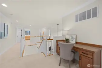 There is a built in desk at the top of the stair landing.