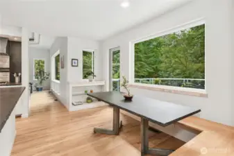 This perfect nook area with a built-in bench and honed granite table, designed for this space, is perfect for morning coffee or casual dining.