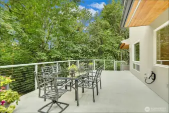 Expansive entertainment deck along the back of the house, perfect for enjoying your morning coffee or summer BBQs. A stunning extension of the home, surrounded by nature.