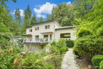 A beautiful flagstone walkway leads to a secluded seating area, offering complete privacy.