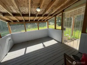 Enclosed back porch makes the perfect catio or place to relax