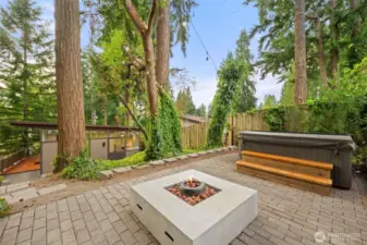 Upper tier, paver patio. Hot tub and gas fire pit stays wit the home.