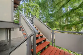 Exterior stairs connect the upper main living area with the lower flex space and utility/storage room.