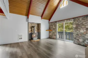 Check out this open living room space with river rock accent, gas fireplace and tongue & grove ceilings.