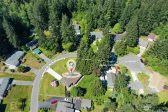 Aerial Photo of house, large lot with fenced back yard, 1000 sq ft shop with private entrance just off of the cul-de-sac.