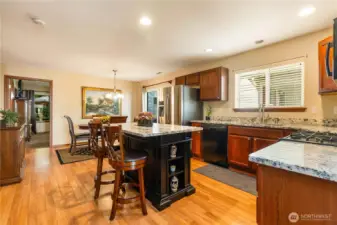 Kitchen with island and slab granite counters