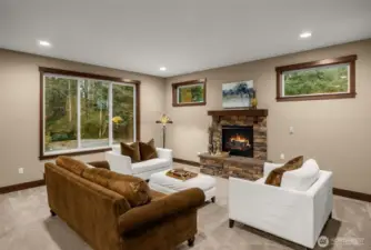 Your light and bright living room is surrounded by windows and a cozy gas fireplace.
