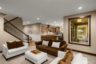 The living room connects seamlessly to the kitchen and offers a view of the outdoor space.