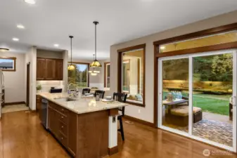 Easily seat 4+ at this large island. Notice the desk area beyond the island. Or add a beverage frig here for a built-in bar area. A walk-in pantry is behind the desk area.