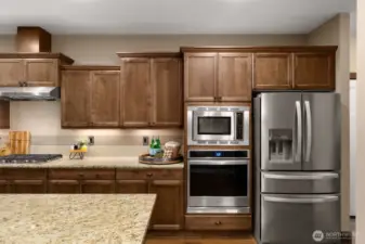 Slab granite counters, a gas cooktop and stainless-steel appliances complete this high-end kitchen.