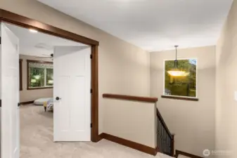 At the top of the stairs behind these French doors is the primary suite.