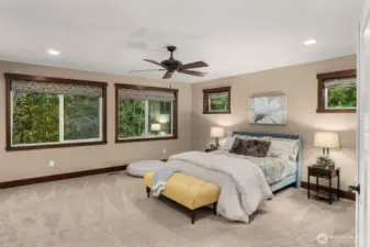 The primary bedroom is large and the oversized windows provide excellent natural light and a lovely view of the green belt.