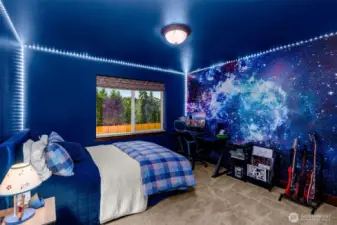 In addition to the primary suite, there are 3 large bedrooms upstairs.  This is 2 of 3 upstairs bedrooms. A perfect room for gamers and stargazers.