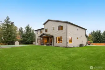 Notice the shed beyond the sport court. Extra storage for your yard tools. And yes – there is AC for this home (see unit on the right).